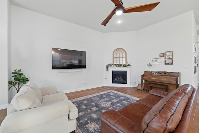 1105 Collared Dove Dr, Little Elm, TX 75068 - living area with wood finished floors, a ceiling fan, baseboards, a glass covered fireplace, and recessed lighting