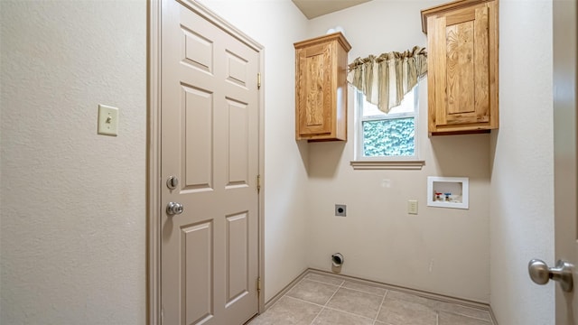 810 Prairie Wind Blvd, Stephenville, TX 76401 - laundry room with electric dryer hookup, cabinet space, light tile patterned floors, and washer hookup