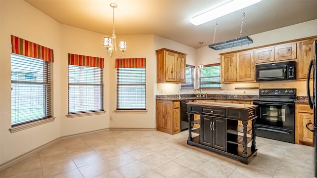 810 Prairie Wind Blvd, Stephenville, TX 76401 - kitchen featuring black appliances, dark countertops, a chandelier, decorative light fixtures, and light tile patterned floors