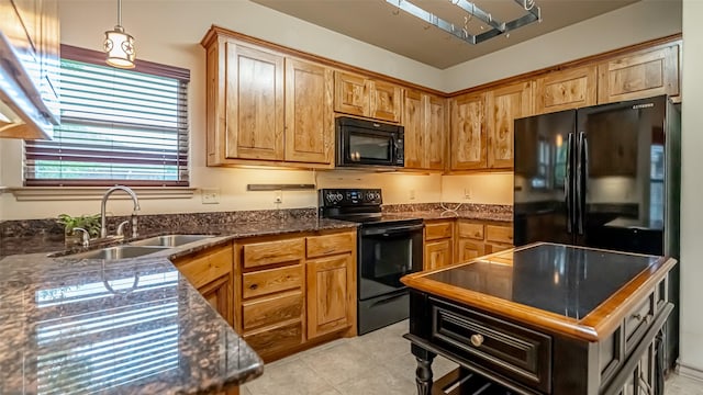 810 Prairie Wind Blvd, Stephenville, TX 76401 - kitchen with black appliances, a sink, light tile patterned floors, pendant lighting, and dark stone counters