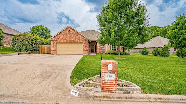 810 Prairie Wind Blvd, Stephenville, TX 76401 - view of front of property featuring concrete driveway, a garage, a front yard, and brick siding