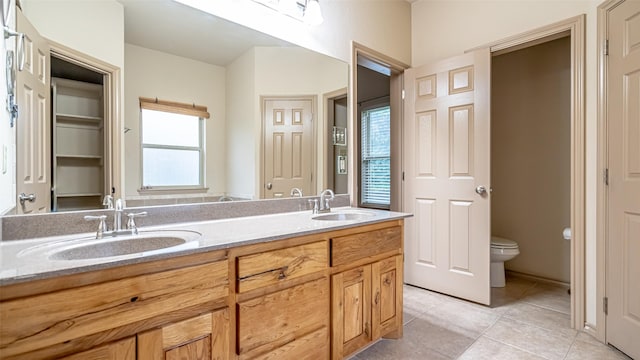 810 Prairie Wind Blvd, Stephenville, TX 76401 - bathroom featuring toilet, tile patterned floors, and double vanity