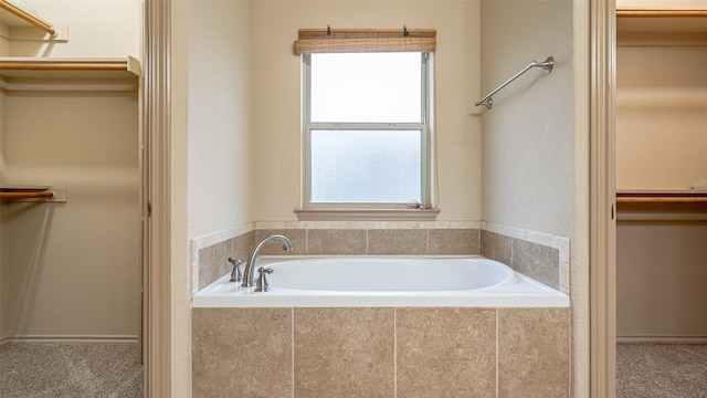810 Prairie Wind Blvd, Stephenville, TX 76401 - bathroom featuring a walk in closet and a garden tub
