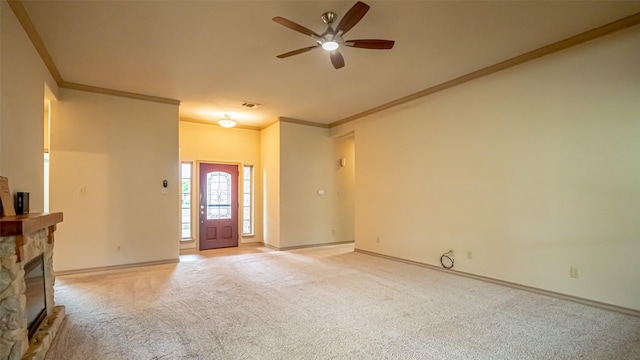 810 Prairie Wind Blvd, Stephenville, TX 76401 - unfurnished living room with ornamental molding, ceiling fan, light carpet, a stone fireplace, and baseboards