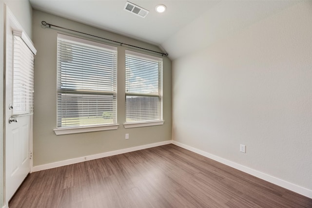 2122 Slow Stream Dr, Royse City, TX 75189 - spare room with wood finished floors, vaulted ceiling, and baseboards