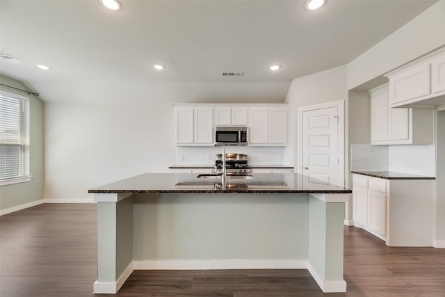 2122 Slow Stream Dr, Royse City, TX 75189 - kitchen with stainless steel microwave, a sink, dark wood-style floors, backsplash, and recessed lighting