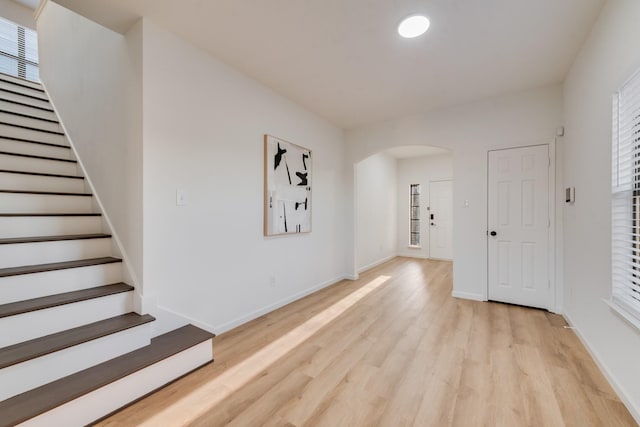 3732 Venera St, Fort Worth, TX 76106 - entryway featuring arched walkways, light wood-type flooring, stairs, and baseboards