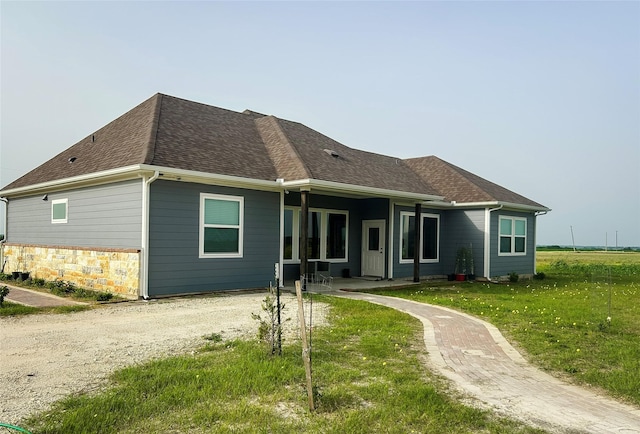 397 Hcr 2341, Abbott, TX 76621 - back of house with a lawn, roof with shingles, and stone siding