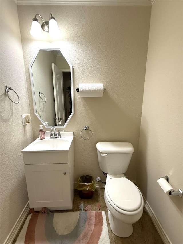8608 Davis Dr, Frisco, TX 75036 - half bathroom featuring toilet, vanity, and baseboards