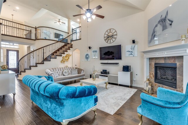 1324 Needle Cactus Dr, Fort Worth, TX 76177 - living area featuring high vaulted ceiling, stairs, ceiling fan, a tile fireplace, and dark wood finished floors