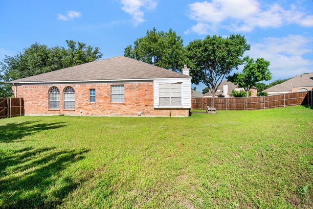 1325 Bentley Dr, Carrollton, TX 75006 - rear view of property featuring brick siding, a chimney, and roof with shingles