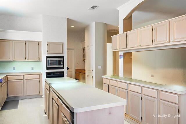 1325 Bentley Dr, Carrollton, TX 75006 - kitchen with stainless steel microwave, wall oven, light countertops, a kitchen island, and recessed lighting