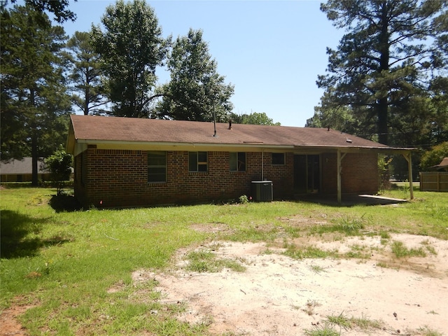 4180 Glenn Rd, Shreveport, LA 71107 - back of house featuring brick siding, central air condition unit, and a yard