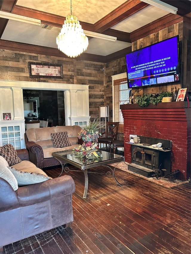 504 E 4th St, Mount Pleasant, TX 75455 - living room featuring wooden walls, a chandelier, hardwood / wood-style floors, and beam ceiling