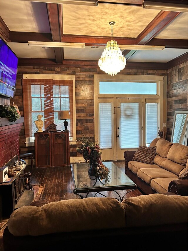 504 E 4th St, Mount Pleasant, TX 75455 - living room featuring wooden walls, coffered ceiling, dark wood finished floors, beam ceiling, and a chandelier