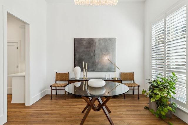 living area featuring wood finished floors, plenty of natural light, and baseboards