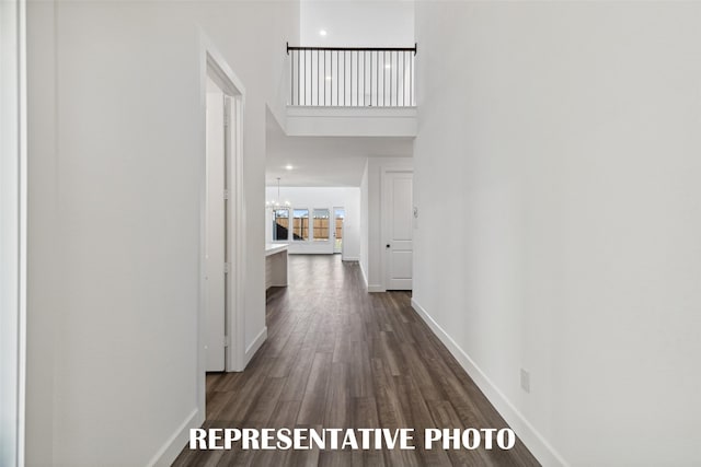 130 Scottish Way, Mansfield, TX 76063 - hall with dark wood-type flooring, baseboards, a high ceiling, and a chandelier