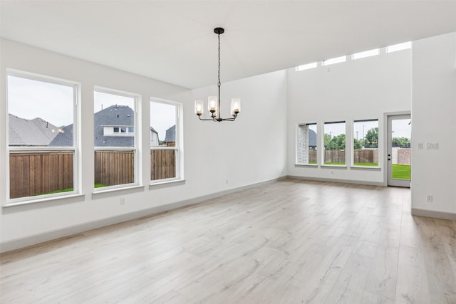 130 Scottish Way, Mansfield, TX 76063 - unfurnished dining area with a chandelier, light wood-style floors, and baseboards