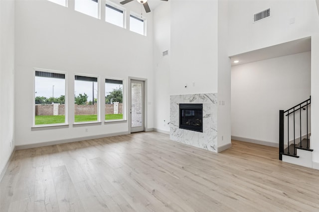 130 Scottish Way, Mansfield, TX 76063 - unfurnished living room with ceiling fan, a high ceiling, stairway, wood finished floors, and a fireplace