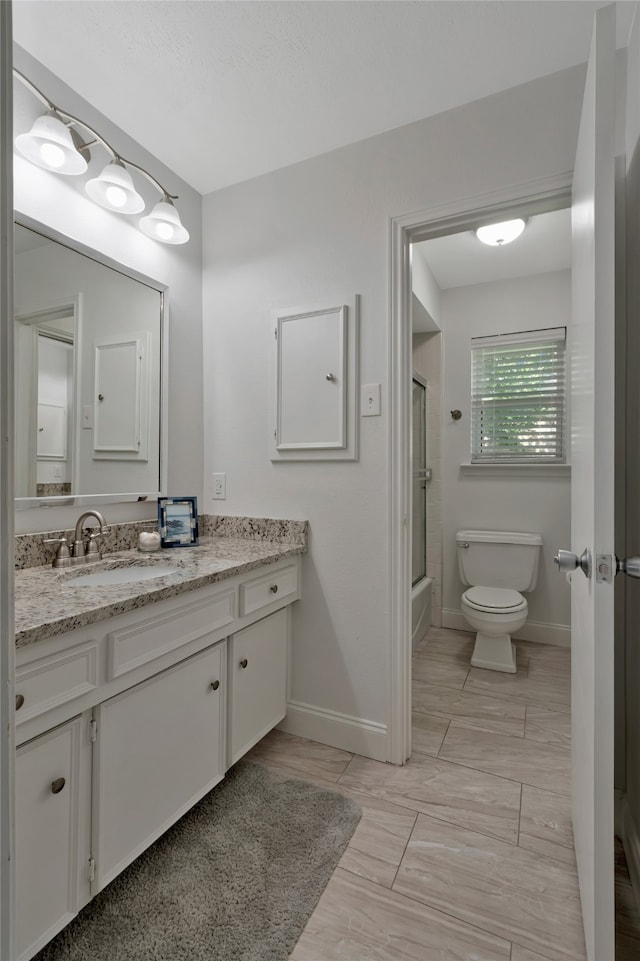 7624 Kevin Dr, Dallas, TX 75248 - full bathroom featuring toilet, baseboards, vanity, and combined bath / shower with glass door