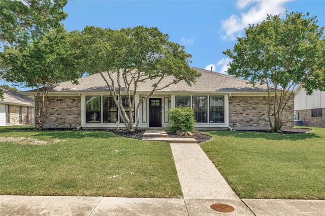 7624 Kevin Dr, Dallas, TX 75248 - ranch-style home featuring brick siding, a front lawn, and roof with shingles