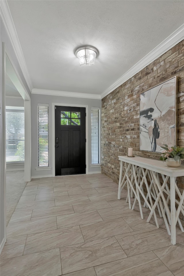 7624 Kevin Dr, Dallas, TX 75248 - foyer with ornamental molding, a textured ceiling, brick wall, and baseboards