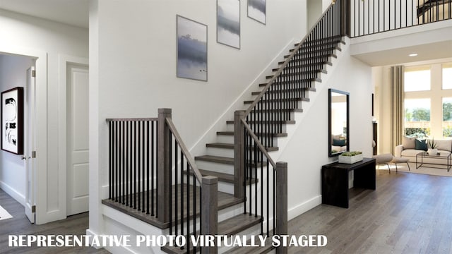 2112 Wakefield Ln, Allen, TX 75013 - stairway featuring wood finished floors, baseboards, and a high ceiling