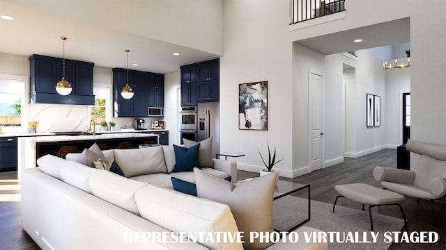 2112 Wakefield Ln, Allen, TX 75013 - living area featuring dark wood-style floors, a chandelier, baseboards, recessed lighting, and a high ceiling
