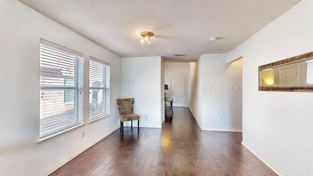 2225 Marion Dr, Mckinney, TX 75072 - unfurnished room featuring dark wood finished floors, baseboards, and a textured ceiling