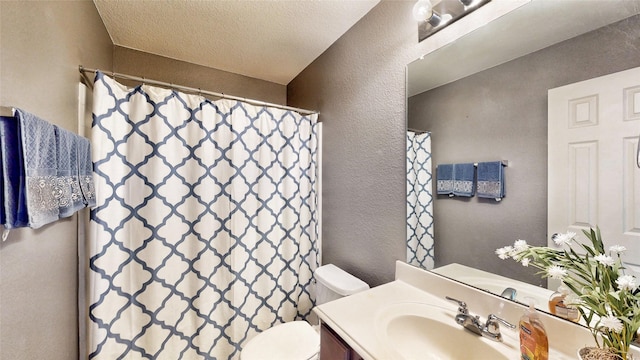 2225 Marion Dr, Mckinney, TX 75072 - bathroom featuring a textured wall, toilet, vanity, and a shower with shower curtain