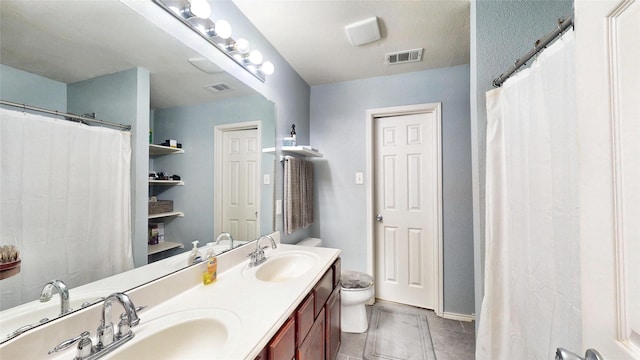 2225 Marion Dr, Mckinney, TX 75072 - full bath with double vanity, toilet, and tile patterned flooring