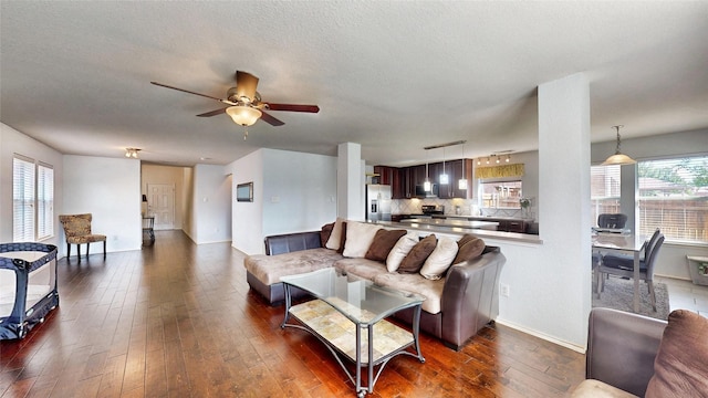 2225 Marion Dr, Mckinney, TX 75072 - living room with dark wood-style floors, a ceiling fan, and baseboards