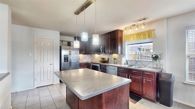 2225 Marion Dr, Mckinney, TX 75072 - kitchen with appliances with stainless steel finishes, a sink, decorative backsplash, baseboards, and a kitchen island