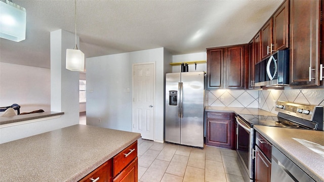 2225 Marion Dr, Mckinney, TX 75072 - kitchen featuring stainless steel appliances, decorative backsplash, light tile patterned flooring, decorative light fixtures, and a textured ceiling