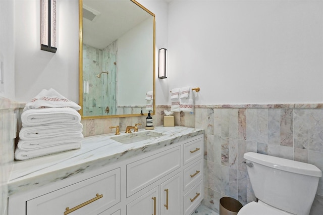 3219 Saint Johns Dr, Highland Park, TX 75205 - full bath with tile walls, vanity, toilet, a marble finish shower, and wainscoting