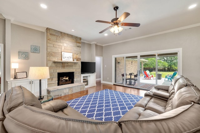 941 Mccampbell Rd, Mansfield, TX 76063 - living room featuring ornamental molding, wood finished floors, a ceiling fan, a stone fireplace, and baseboards