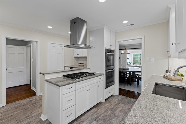 3824 Arundel Ave, Fort Worth, TX 76109 - kitchen with stainless steel appliances, a sink, island exhaust hood, crown molding, and a chandelier