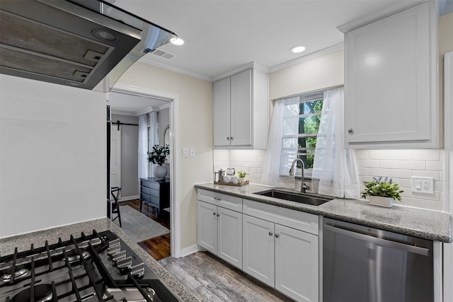 3824 Arundel Ave, Fort Worth, TX 76109 - kitchen with stainless steel appliances, a sink, ornamental molding, wood finished floors, and backsplash