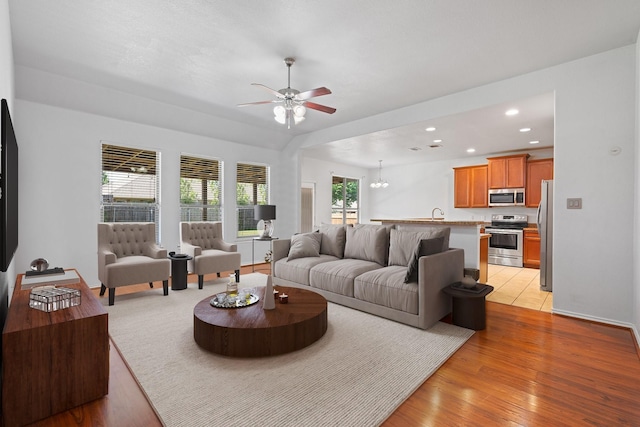 303 Stonegate Blvd, Alvarado, TX 76009 - living room featuring ceiling fan, light wood-style floors, recessed lighting, and a chandelier