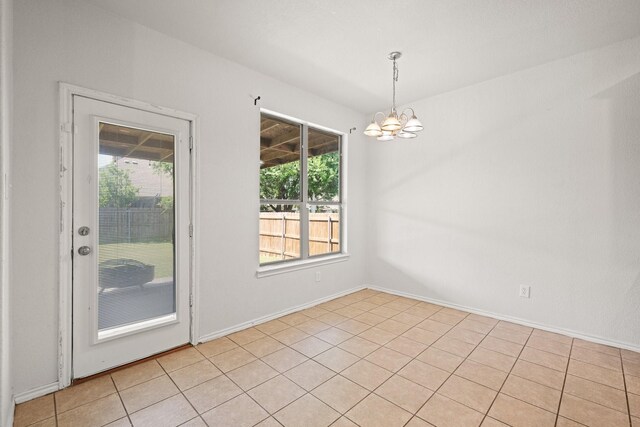 303 Stonegate Blvd, Alvarado, TX 76009 - spare room with a chandelier, light tile patterned flooring, and baseboards