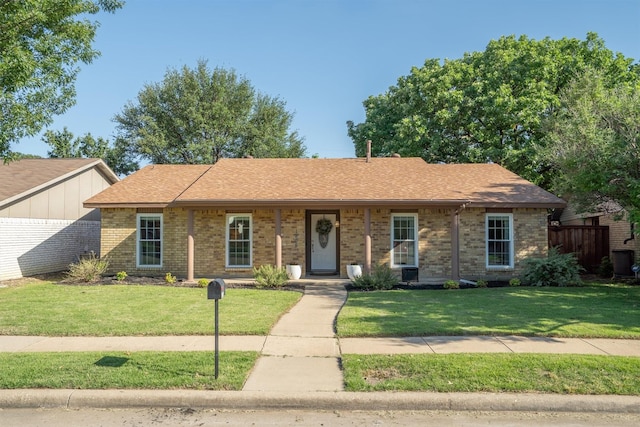 ranch-style house featuring brick siding and a shingled roof