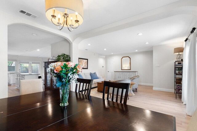 dining room with light wood-style floors, baseboards, recessed lighting, and a chandelier