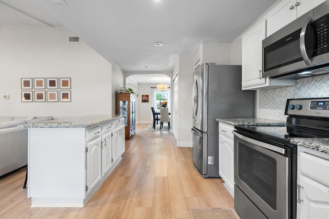 kitchen featuring appliances with stainless steel finishes, white cabinetry, light wood-type flooring, and recessed lighting