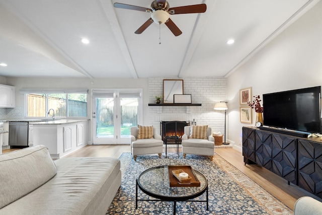 living area with light wood finished floors, a fireplace, a ceiling fan, recessed lighting, and baseboards