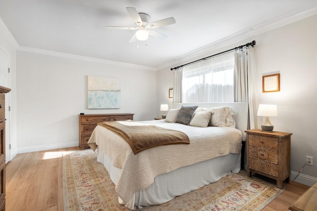 bedroom featuring ornamental molding, light wood-type flooring, baseboards, and ceiling fan