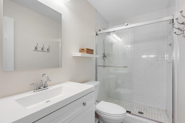 full bathroom featuring toilet, a shower stall, and vanity