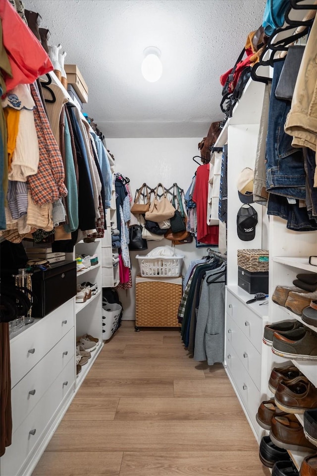 spacious closet with light wood finished floors