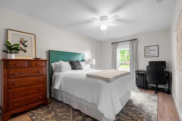 bedroom with wood finished floors, ceiling fan, and baseboards