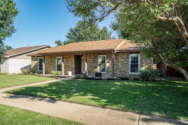 ranch-style home featuring brick siding and a shingled roof