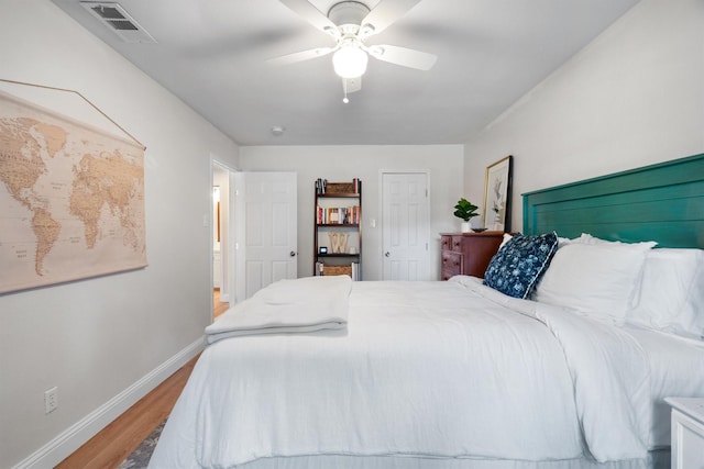 bedroom featuring baseboards, light wood-type flooring, and ceiling fan